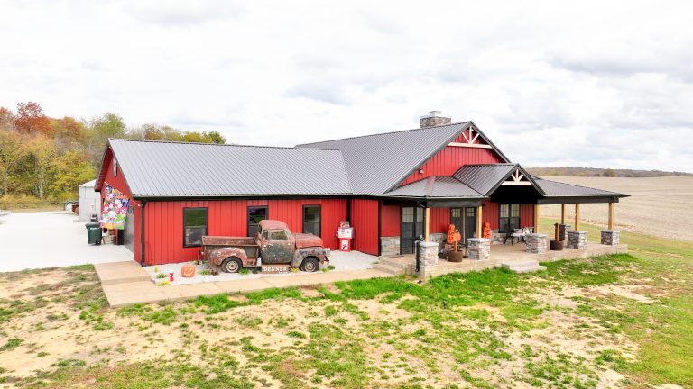 Large barndominium with open layout and efficient design. Rustic colors with red walls and black roof.